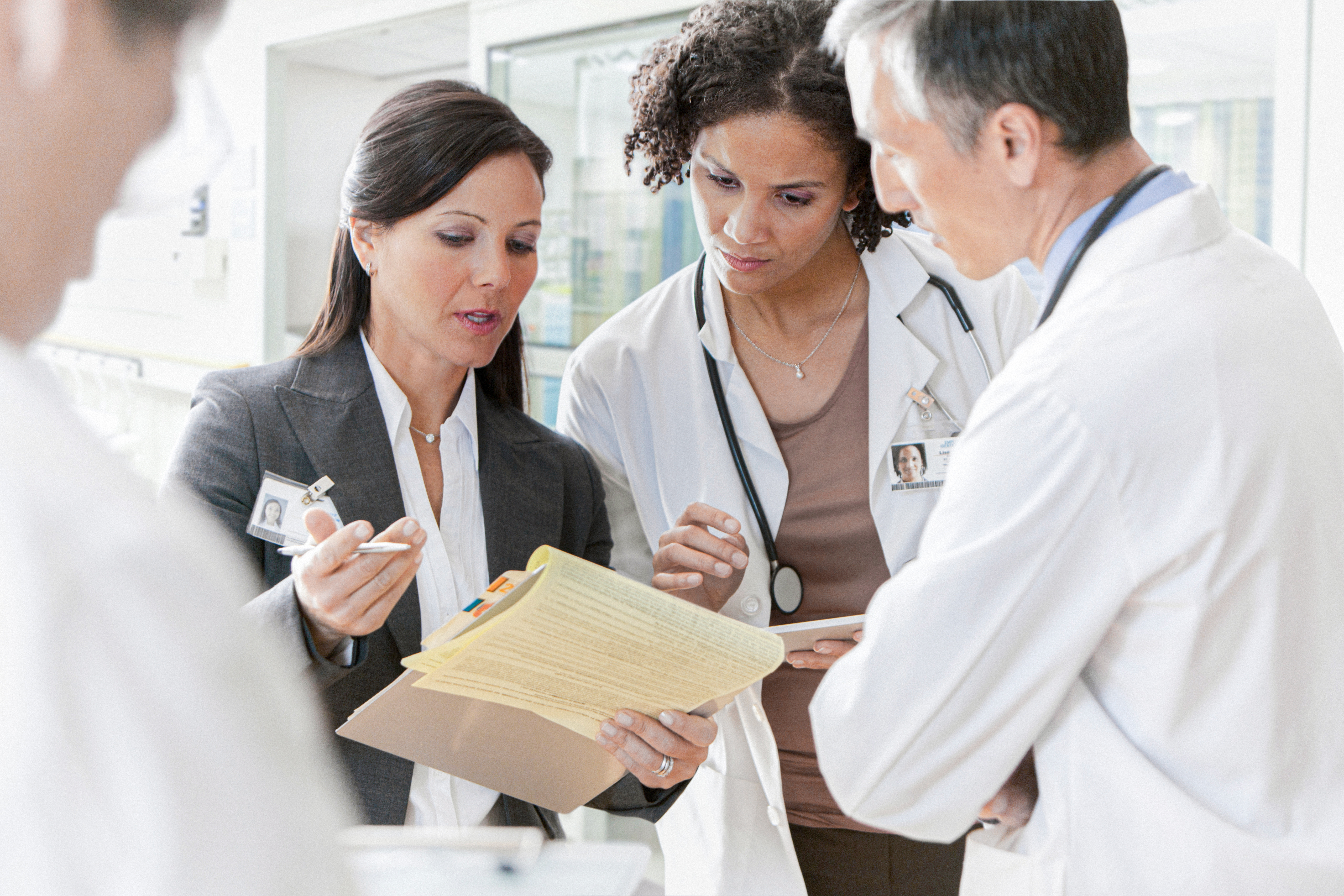 Intrinsiq_Specialty_Solutions_MIPS_consultant_speaking_with_group_of_doctors