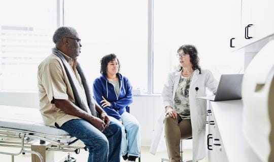 Elderly Black man with community oncology doctor