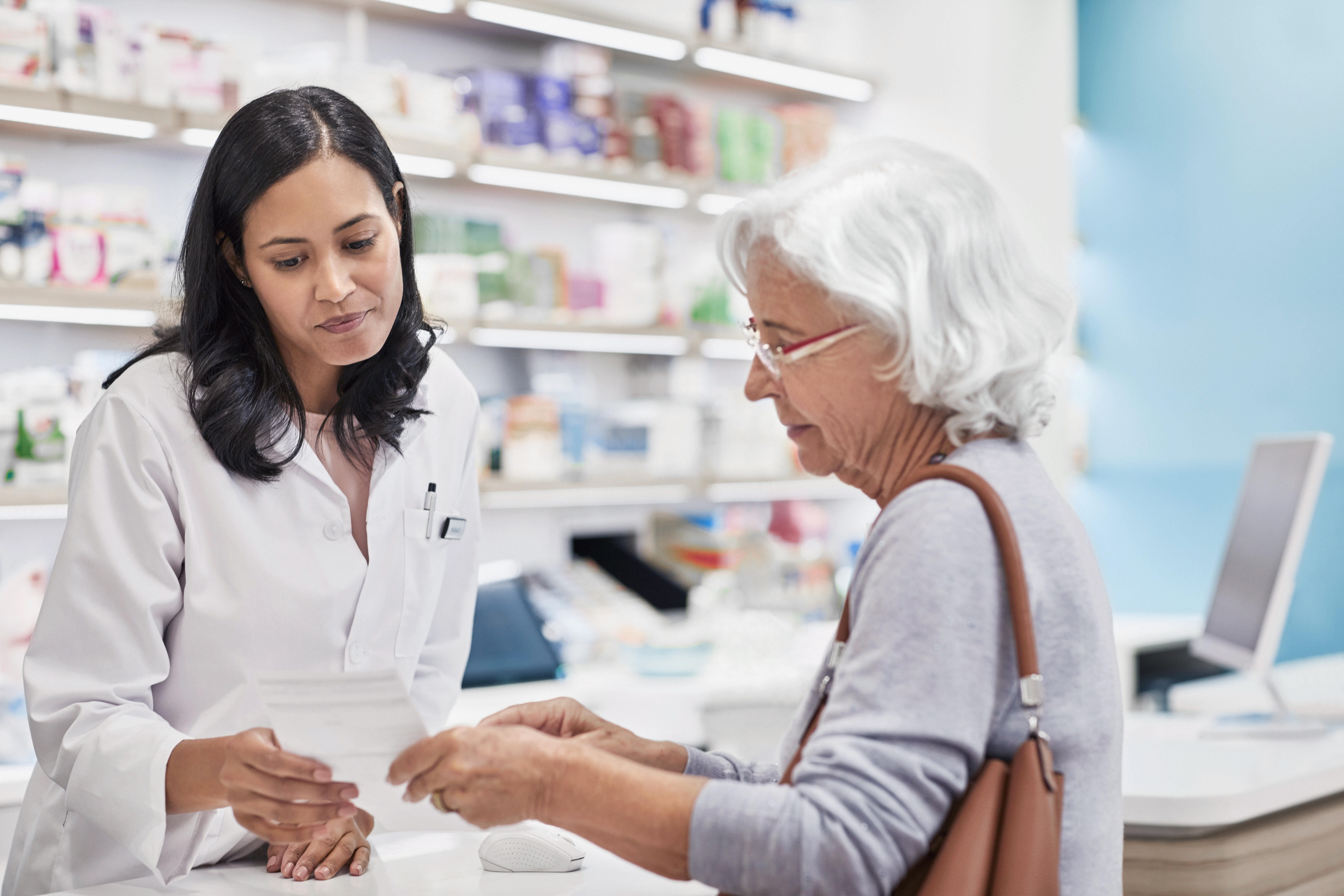 in office pharmacist helps patient